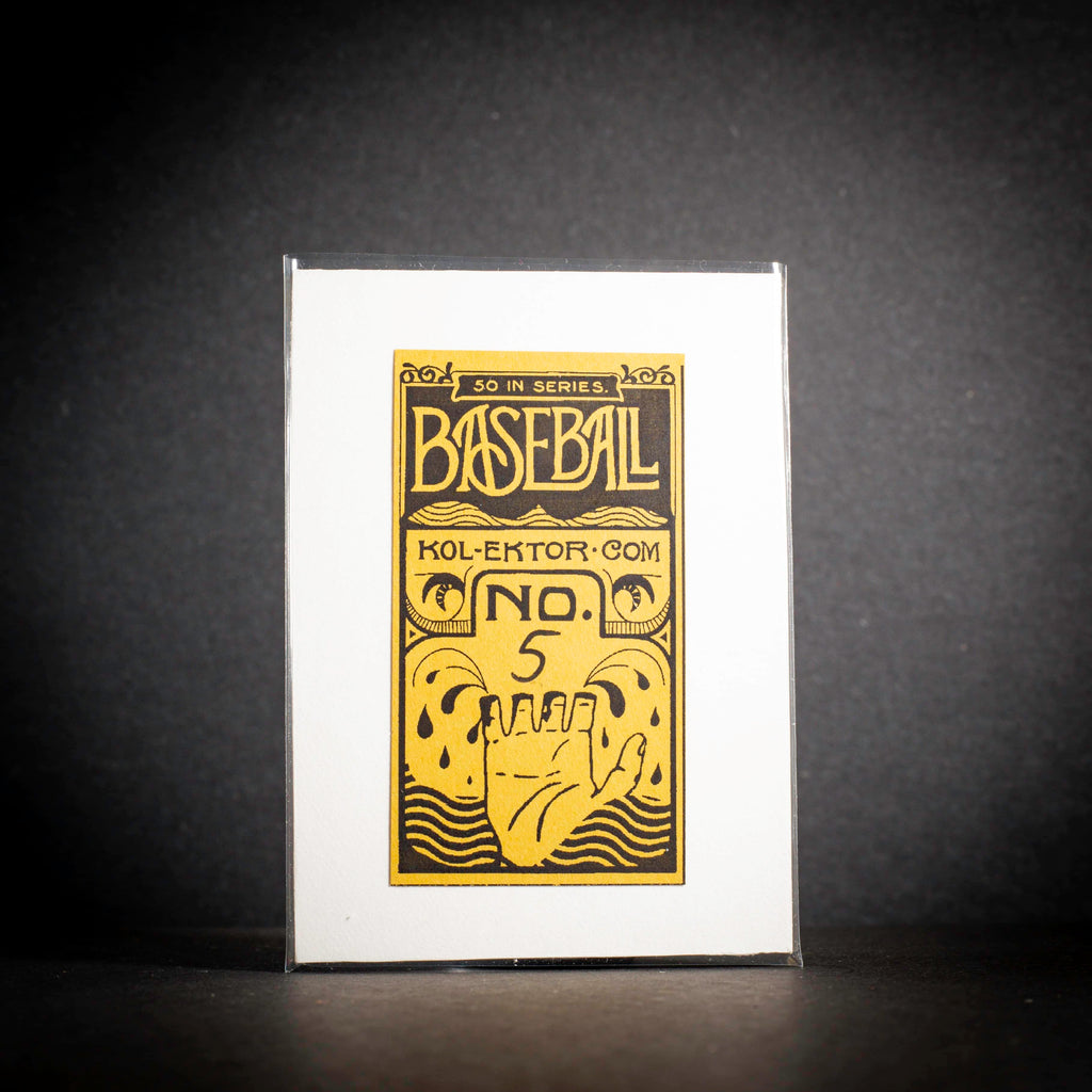 Baseball card packaging with yellow and black design on a dark background