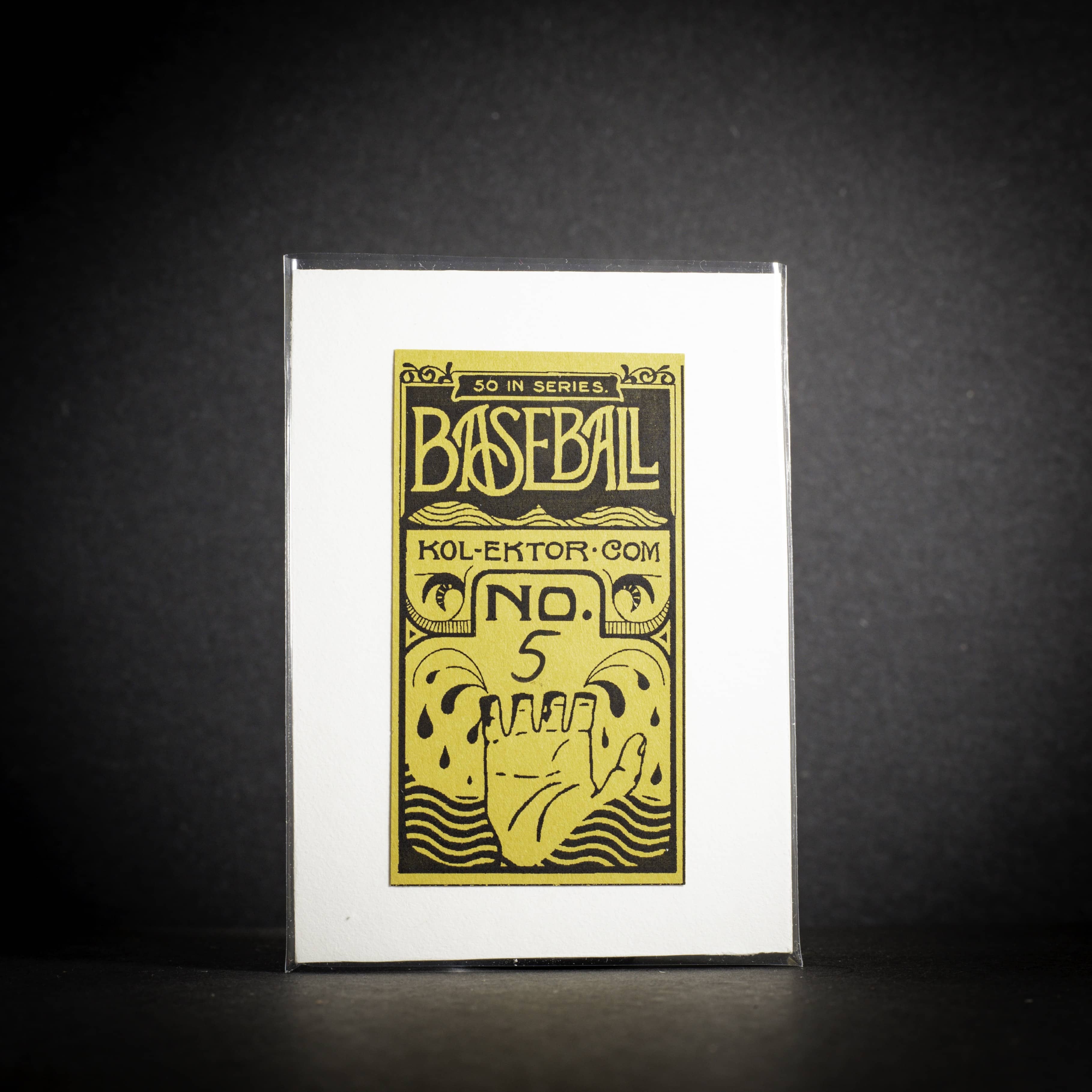 Baseball card packaging with yellow and black design on a dark background