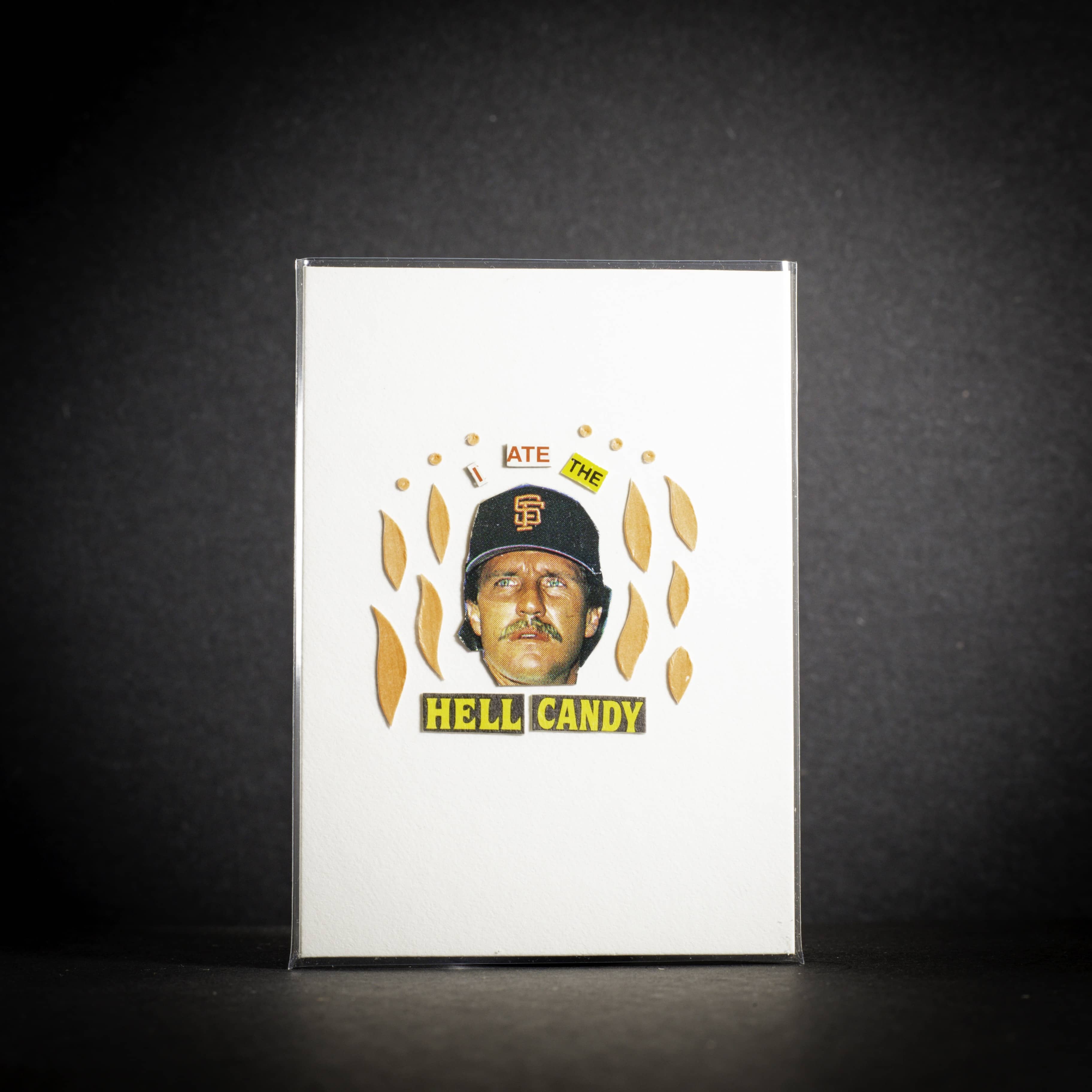 Card with a person wearing a baseball cap and text 'I ate The Hell Candy' on a dark background