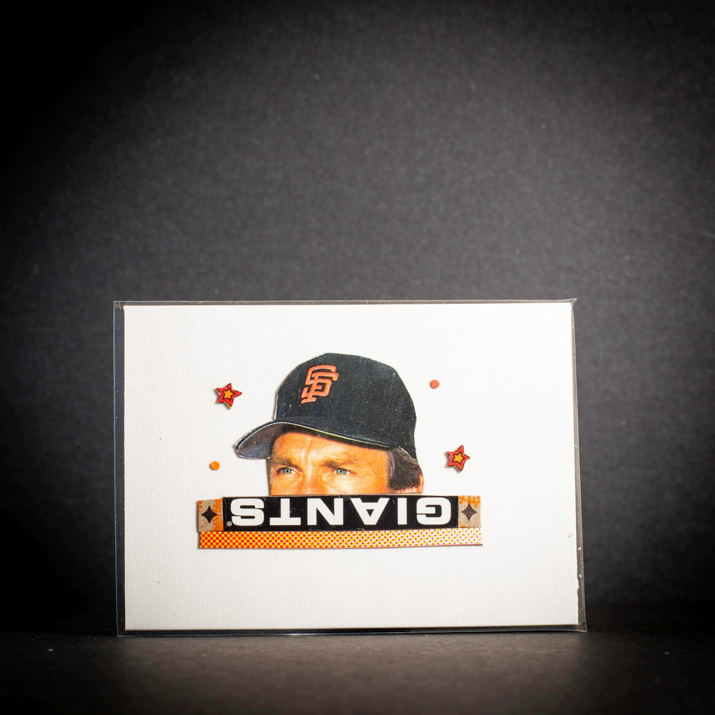Card with a baseball player wearing a Giants cap on a dark background
