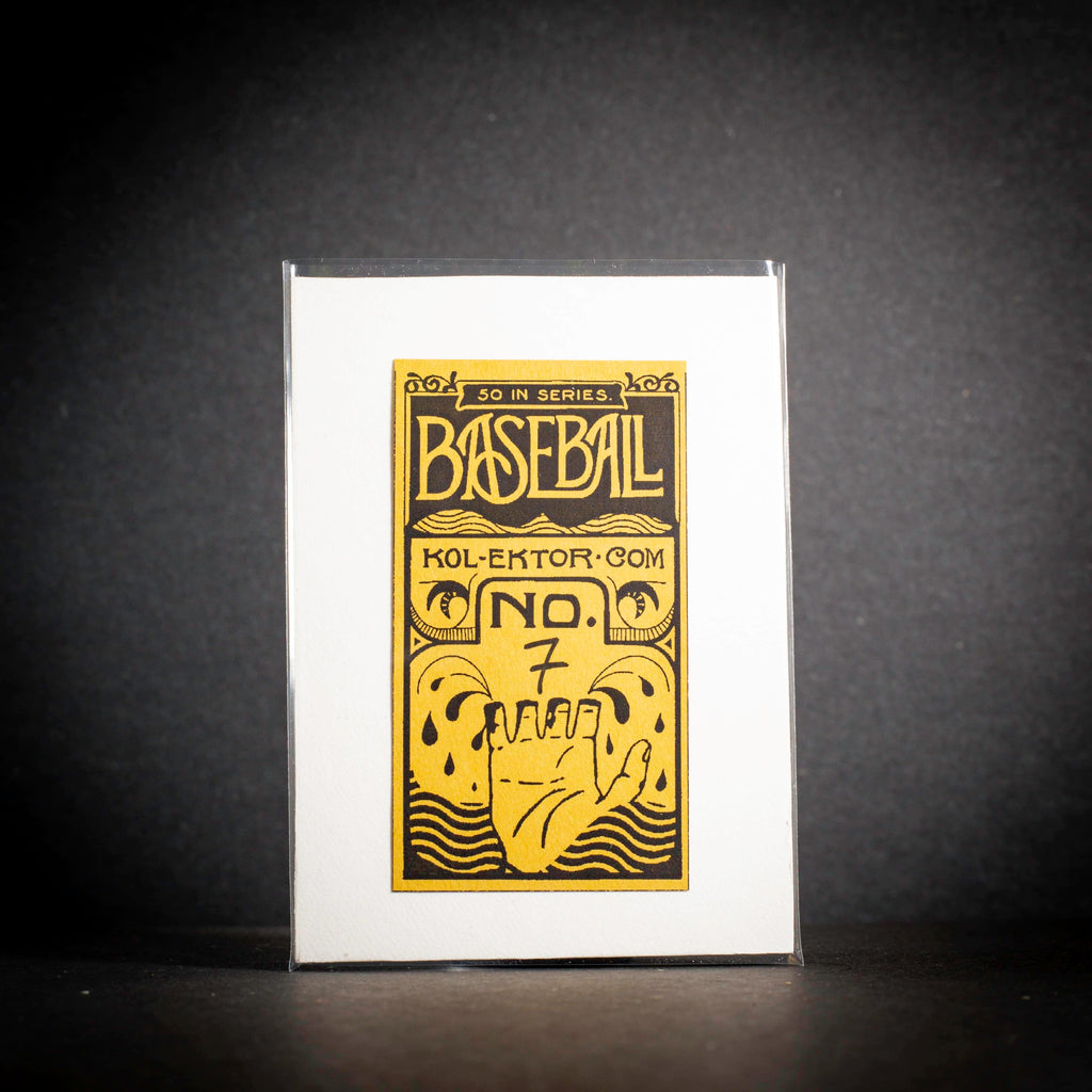 Framed collectible card with yellow text and graphics on a black background