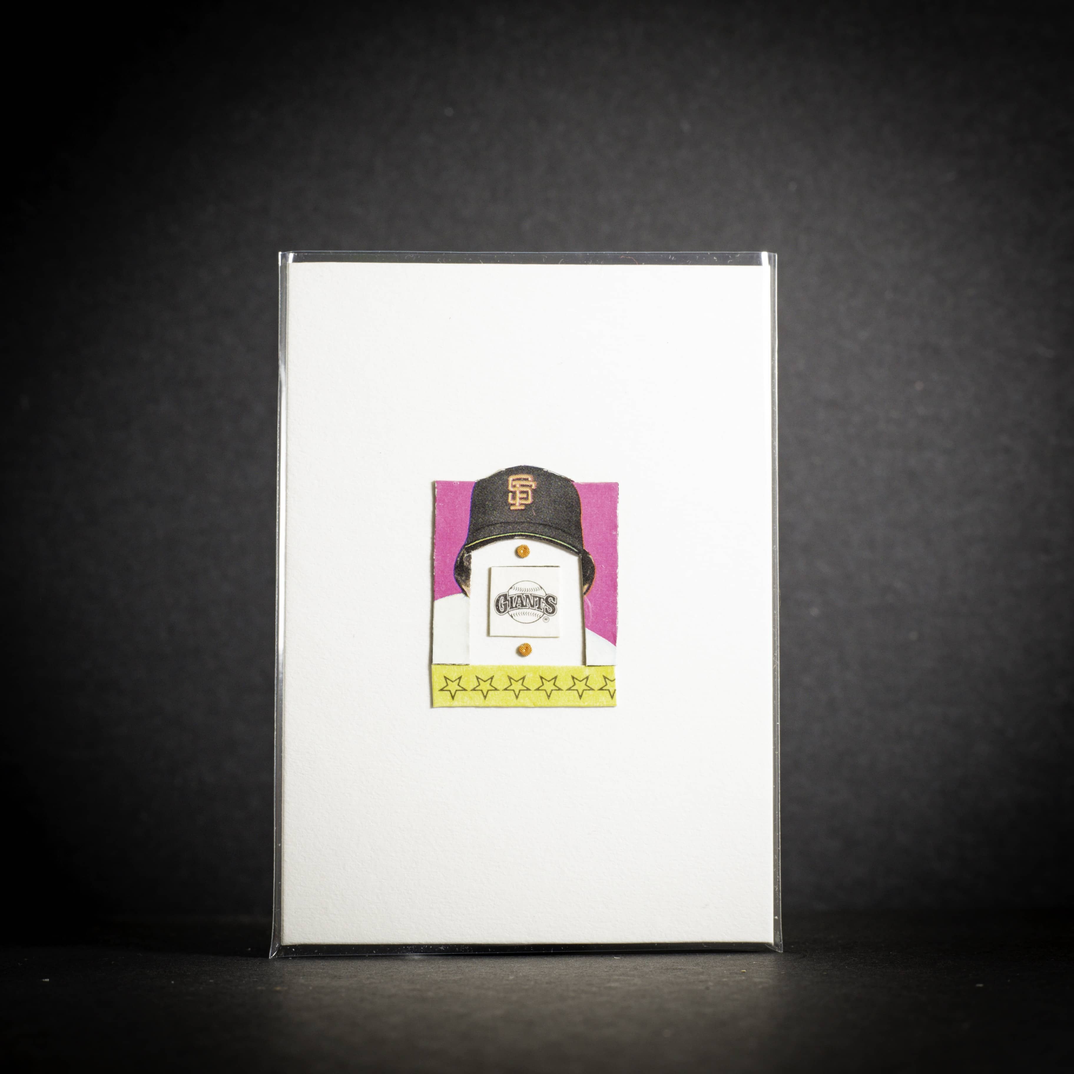 Card with a baseball cap design on a dark background