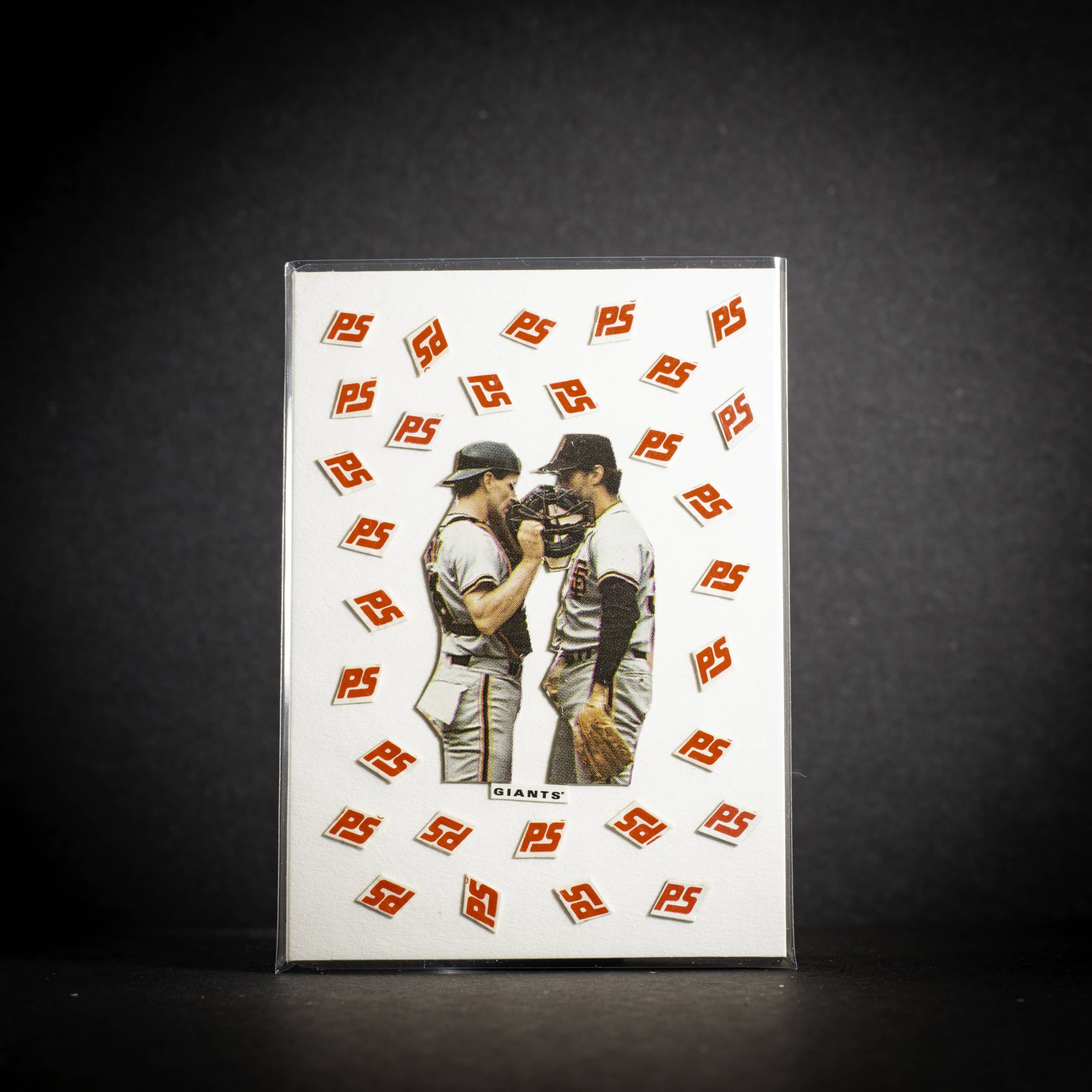 Baseball card with two players hugging on a white background with 'PS' logo pattern