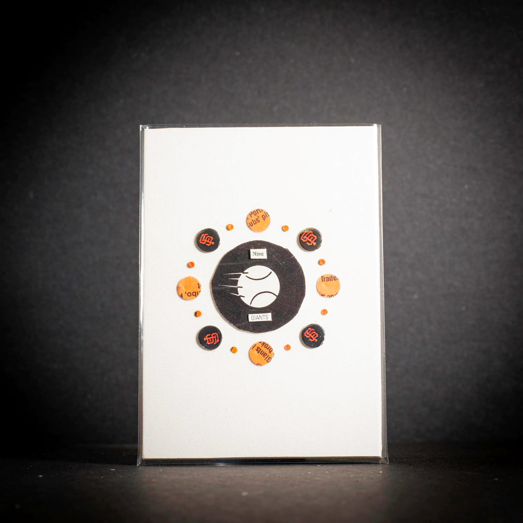 Collection of baseball-themed pins on a white card with a black border against a dark background