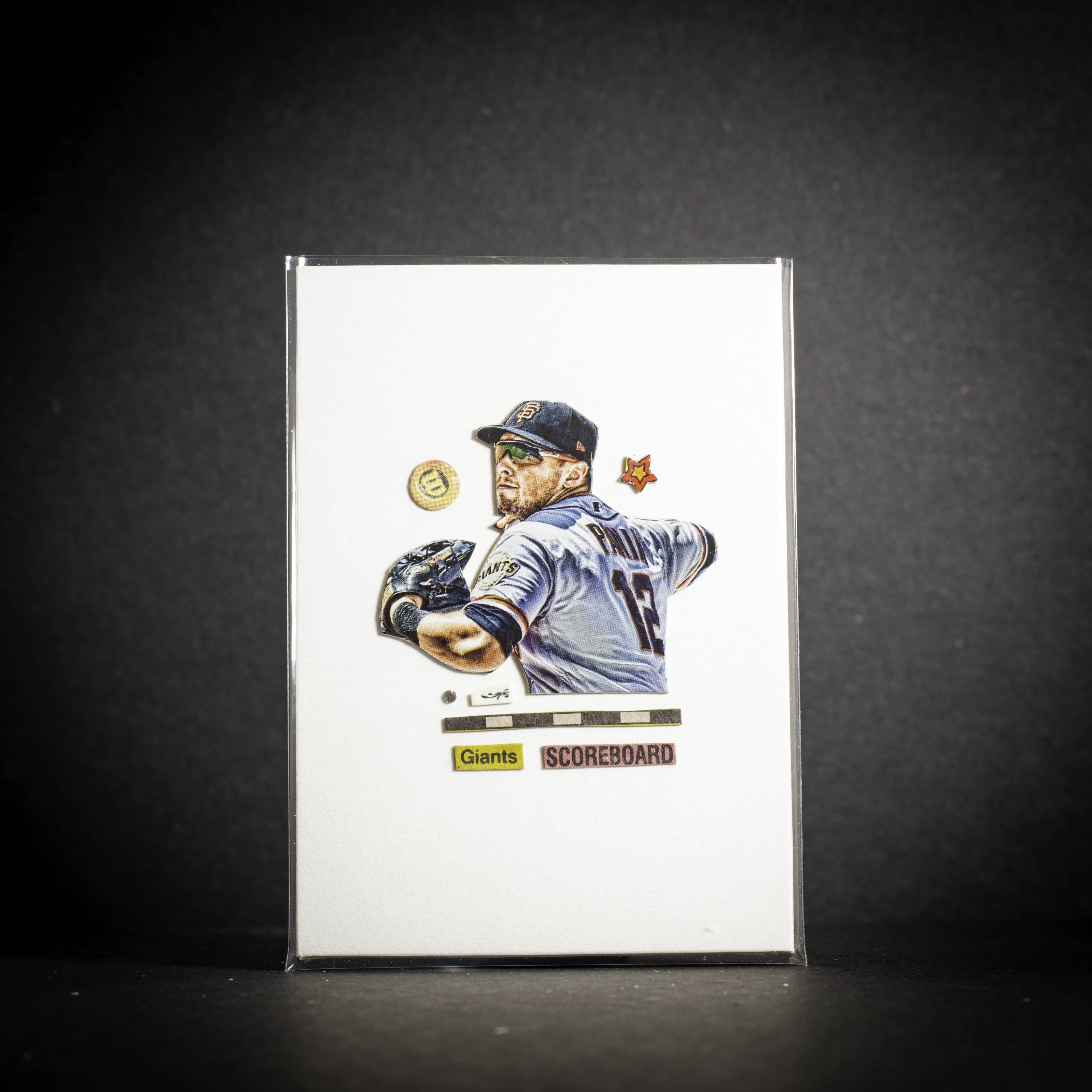 Baseball trading card of a player in a blue jersey with a dark background