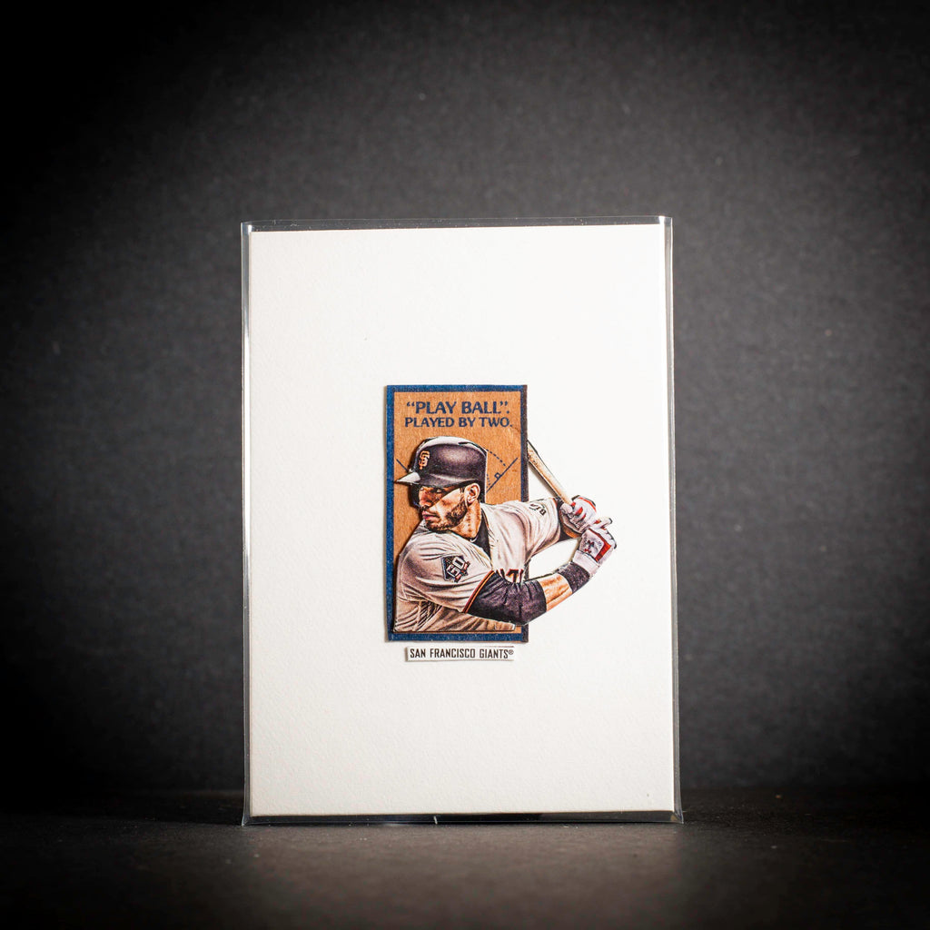 Baseball player card on a reflective surface with a dark background