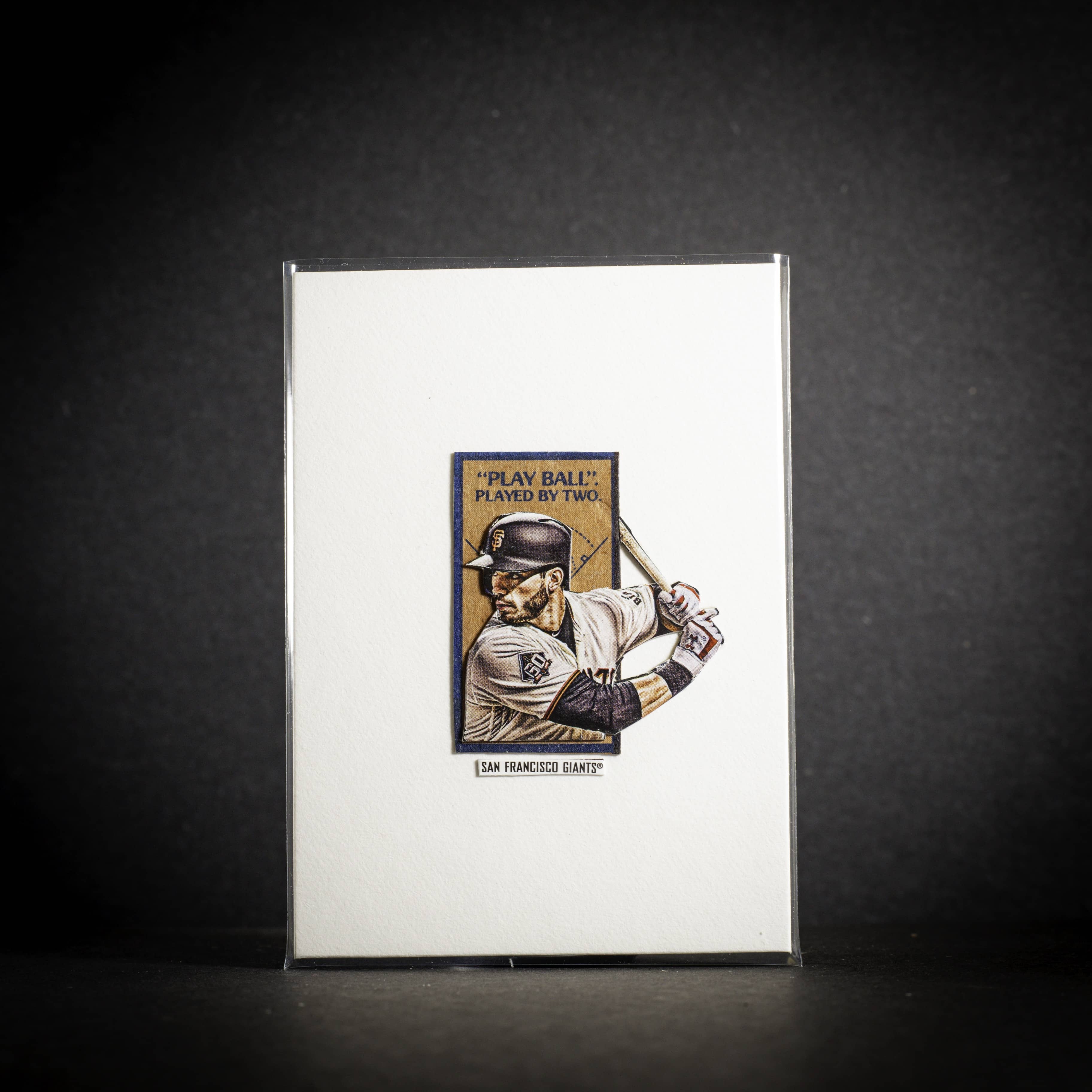 Baseball player card on a reflective surface with a dark background