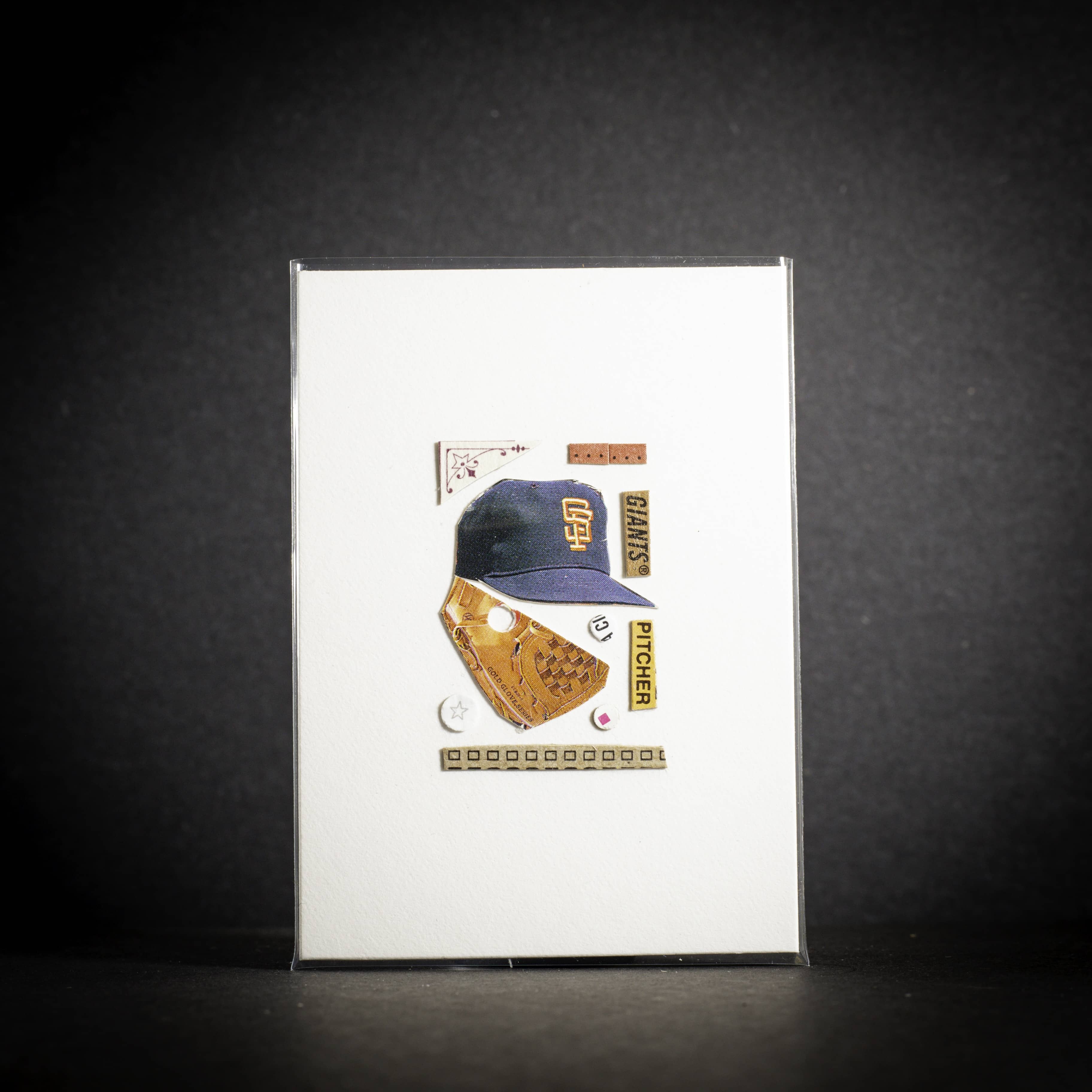 Baseball cap and glove card on a white card with a dark background