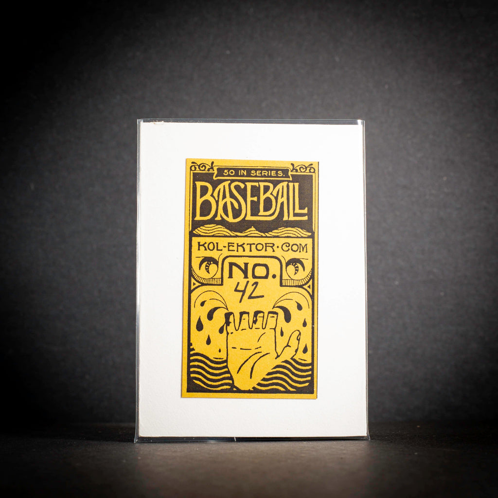 Baseball card packaging with gold and black design on a white background
