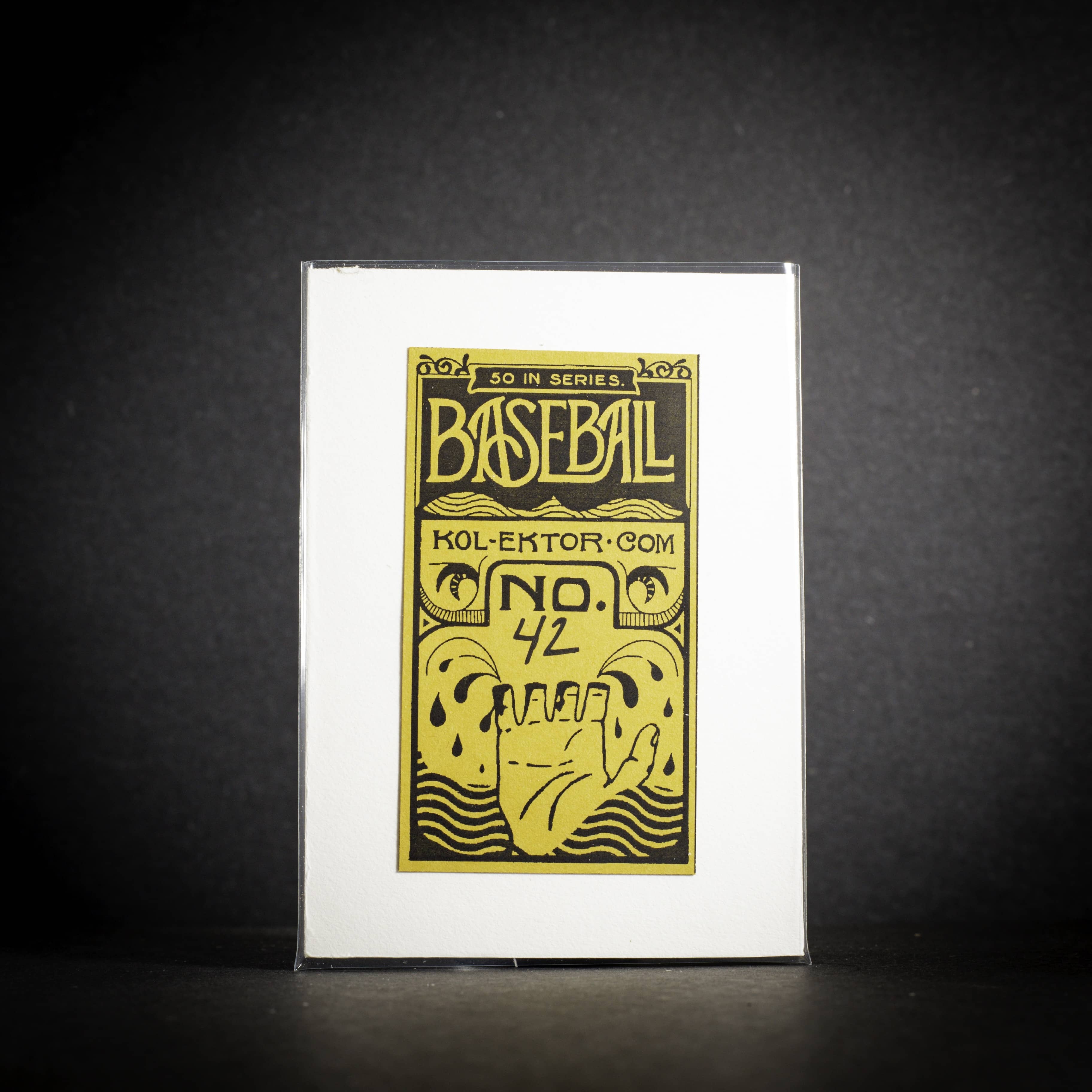 Baseball card packaging with gold and black design on a white background