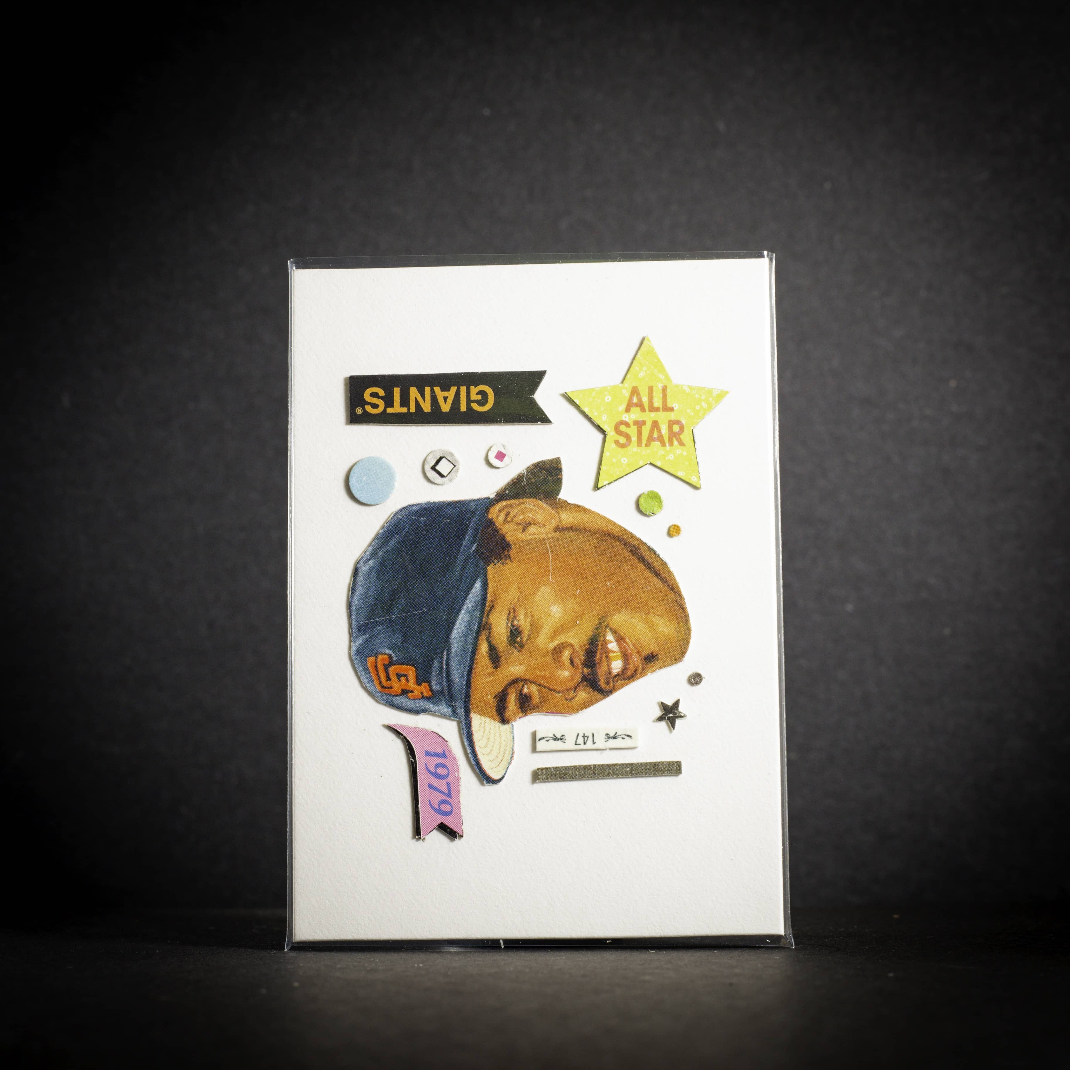 Baseball trading card of a player wearing a Giants cap on a dark background vertical