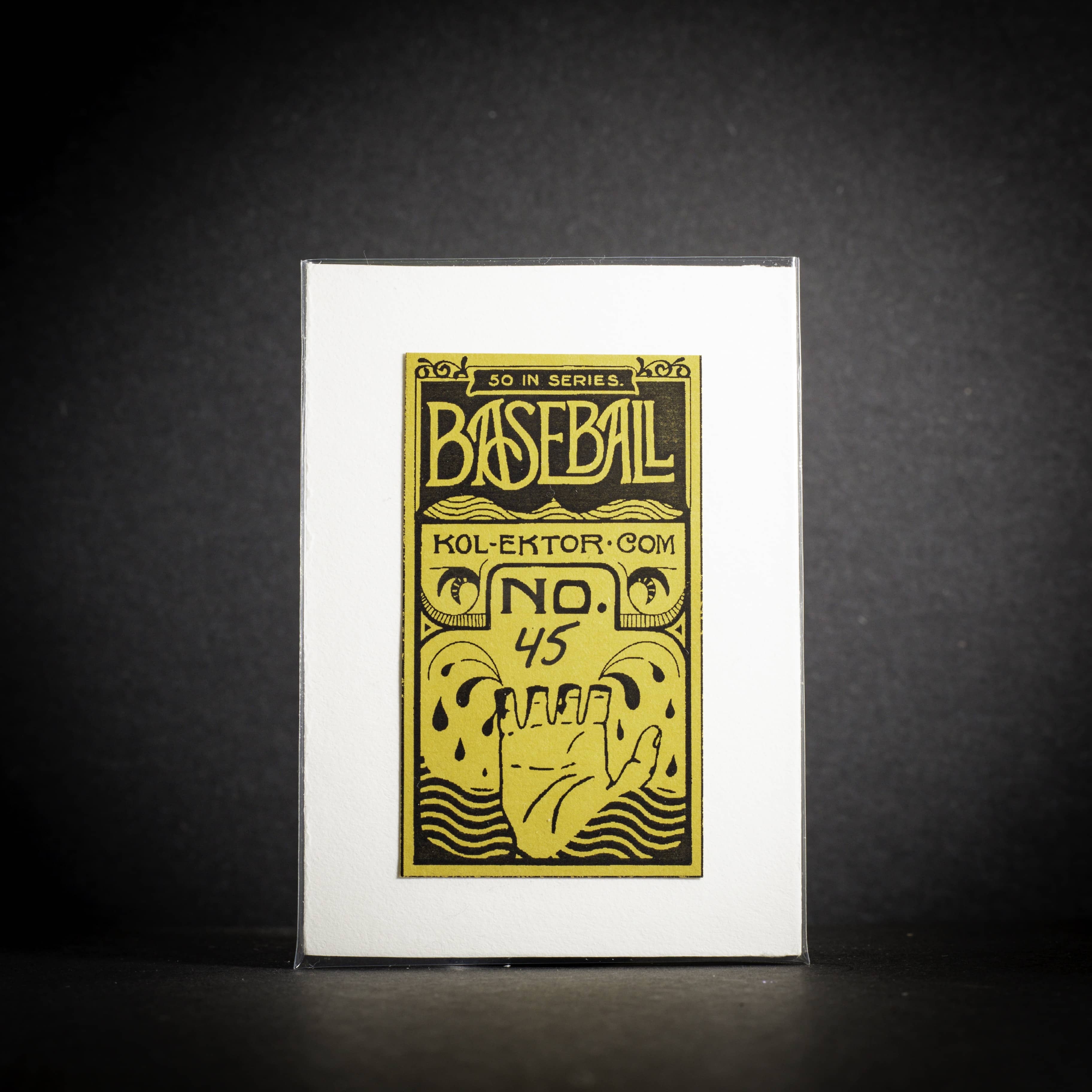 Baseball card with yellow and black design on a white card against a dark background