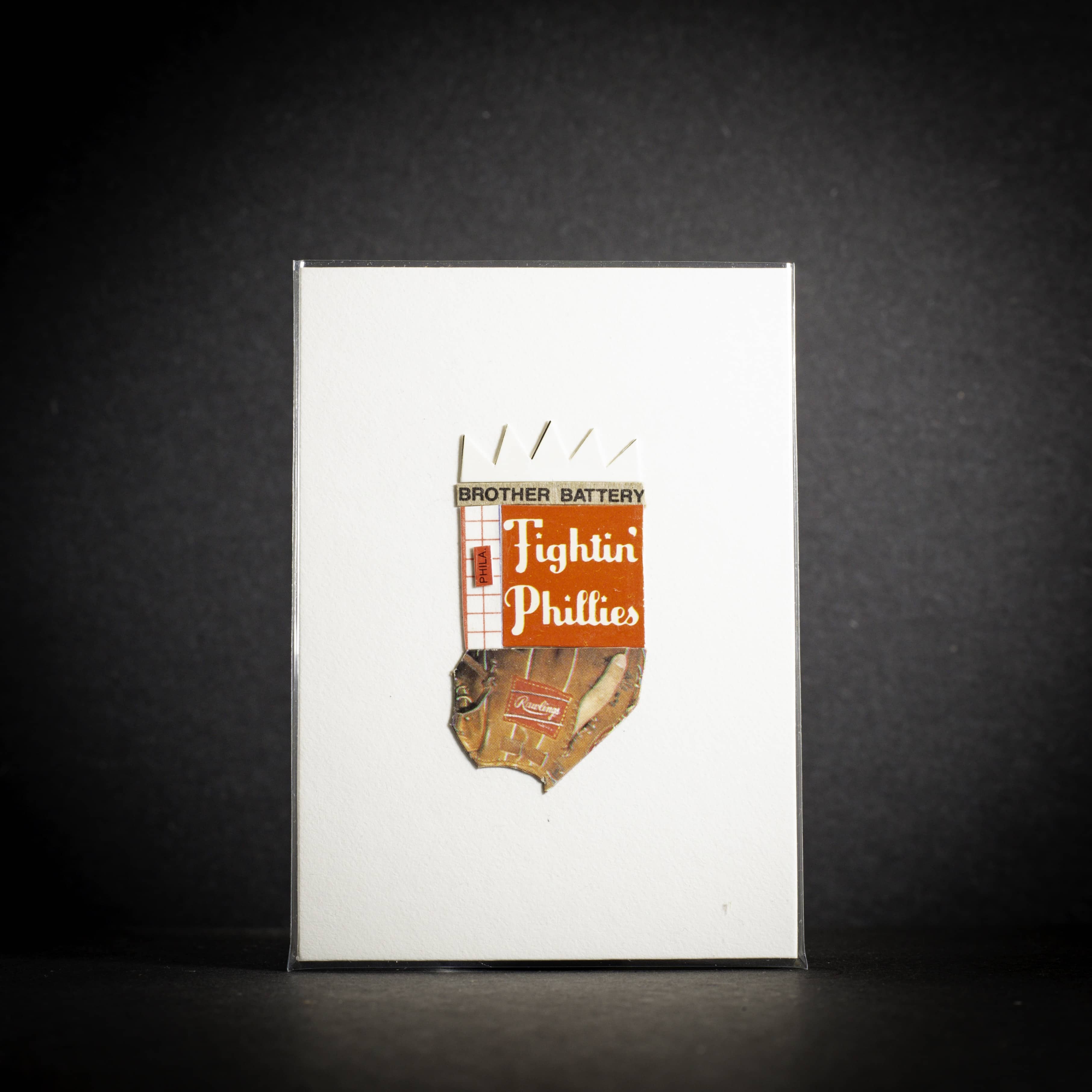 Notebook with 'Brother Battery Fighting Phillies' logo on a dark background